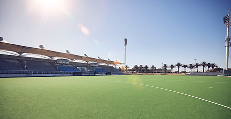Image showing Empty sport field, outdoor grass and training stadium ground in summer ready for sports. Lawn care, sunshine and blue sky by a exercise, workout and game venue isolated and remote for fitness