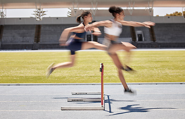 Image showing Fitness, race and hurdles with a black woman and sports athlete racing on a track for endurance competition. Motion blur, energy or running with a female and rival or competitor jumping over a hurdle