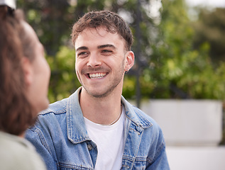 Image showing Happy man, smile and face of gay, homosexual or lgbtq guy sitting outdoor on a date while having a conversation about happiness, lifestyle and love. Gen z male in nature while talking to partner