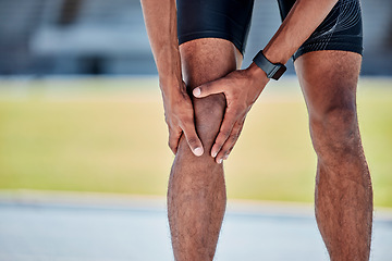 Image showing Runner, knee injury and pain in legs on field, track or sports at training, workout or exercise. Black man, sport and knee pain emergency in running for health, wellness or muscle development outdoor