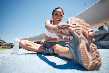 Image showing Runner, stretch and woman athlete with a smile ready for running, training and sports workout. Happy, wellness and fitness of a person stretching legs on the ground outdoor for marathon or exercise