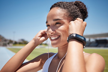 Image showing Face, music and fitness with a black woman runner or athlete listening to audio during endurance training. Workout, earbuds and exercise with a female getting ready for a run on a sports track