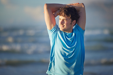 Image showing Stretching, beach fitness and man on morning cardio run, sports workout or training for marathon race by the ocean. Sunshine peace, freedom and athlete runner warm up for nature performance exercise