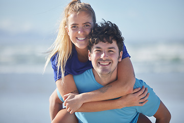 Image showing Couple, portrait and piggy back at beach relaxing in exercise, workout and fitness clothes. Ocean, love and health of happy people enjoying active outdoor lifestyle break together with smile.
