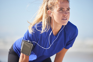 Image showing Music, fitness and woman runner stop to breathe, focus and prepare body for training, exercise and cardio run in a city. Radio, exercise and sports woman relax, stretch and breathing while running