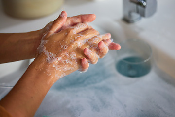 Image showing Hand wash, cleaning and sink washing for healthcare, wellness and virus safety in a bathroom. Skin health, bacteria cleaner and soap with hands using liquid disinfection for corona prevention