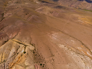 Image showing Aerial shot of the textured yellow nad red mountains resembling the surface of Mars