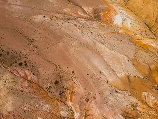 Image showing Aerial shot of the textured yellow nad red mountains resembling the surface of Mars