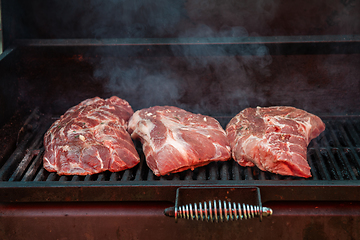 Image showing Pork meat steaks on the grill