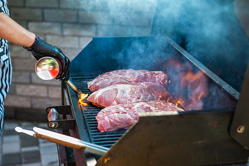 Image showing Pork meat steaks on the grill