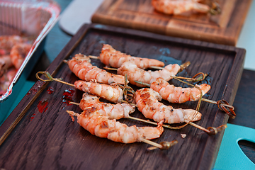 Image showing A professional cook prepares shrimps