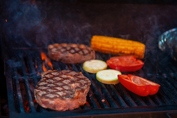 Image showing Pork meat steaks on the grill