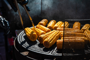 Image showing A professional cook prepares corn