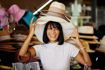 Image showing Woman, hats and smile of a black woman shopping at a retail store with a comic smile. Portrait of a funny and happy sales customer laughing from luxury shop experience in a mall or clothes boutique