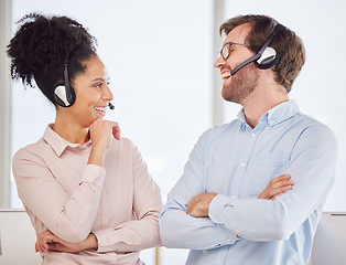 Image showing Call center, man and woman with headset have conversation, talking and discussion with smile, happy and in office. Customer service, client support and diversity with agents, speaking and laughing.