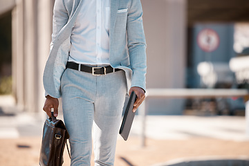 Image showing Businessman, walking to work and with briefcase in city with tablet in hands traveling, outdoor stroll and work in town. Professional employee, walk cityscape street and man in gray suit in sunshine
