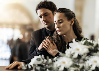 Image showing Sad, funeral and flowers with couple and coffin in church for death, respect and mourning. Grief, goodbye and empathy with man and woman loss at casket with depression, remember and farewell memorial