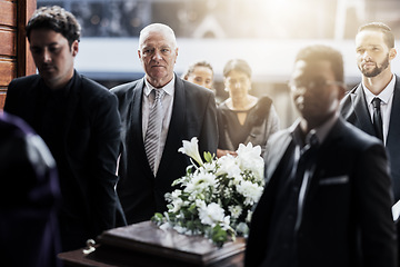 Image showing Sad, funeral and people with coffin at church for service, mourning and grief over death. Flowers, depression and ceremony with family carrying casket in chapel for sorrow, support and loss together