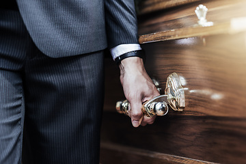 Image showing Funeral, man hands and holding coffin at a sad, death and church even of a person with casket. Support, loss and dead burial of a male at a religion, respect and mourning ceremony with a suit