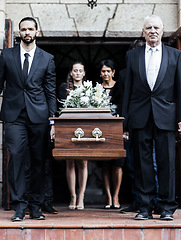 Image showing Funeral, church and people with a coffin, family and mourning in emotional distress. Church service, casket and burial with sad men and women carrying dead person together out of a chapel door