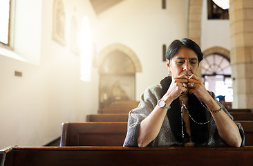 Image showing Pray, church and senior woman praying with a rosary in a calm, zen chapel alone, holy and spiritual. Prayer, worship and mexican lady connect with God, Jesus and christian religion in Mexico