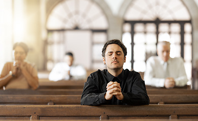 Image showing Prayer, religious and young man in church with congregation, faithful and hands together. Religion, male and worship in tabernacle for guidance, spiritual and support with closed eyes and praying