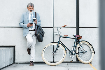 Image showing Businessman, phone and coffee with bicycle in city on social media, web or internet browsing. Tech, bike or senior manager drinking tea while on 5g smartphone app, networking or text message on break