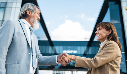 Image showing Partnership, meeting and handshake with business people in city for global merger, collaboration or deal. Thank you, welcome or contract with ceo shaking hands with client for b2b, crm and leadership