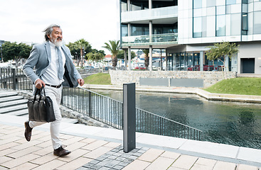 Image showing Businessman, running and work time in the city for urgent meeting, deadline or behind schedule. Elderly man having a run to the office for business deal, appointment or opportunity in the outdoors