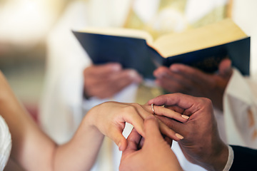 Image showing Couple hands with ring, wedding and marriage in church with priest and bible in traditional ceremony. Commitment, love and jewelry, man and woman together with trust and jewellery with bride.