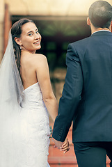 Image showing Wedding, married and man and woman holding hands outside of church after marriage ceremony. Romance, romantic and commitment event for husband and wife hold hand for affection and love or care