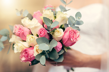 Image showing Wedding, flowers and rose bouquet of bride ready to walk isle for marriage, catholic religion ceremony and life commitment. Boutique floral arrangement, yellow and pink roses in womans hand to marry