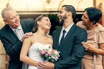 Image showing Wedding, happy and couple with parents at a celebration of love at an event with happiness. Smile, celebrate and young bride and groom after marriage with mother and father together at a church