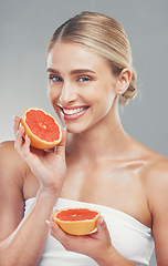 Image showing Beauty, skincare and woman with grapefruit in wellness portrait, healthy skin and face care with smile against studio background. Fresh, clean with facial and vitamin c, cosmetics and natural.