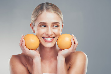Image showing Orange, skincare and woman thinking of cosmetics, beauty and health of body against a grey mockup studio background. Happy, healthy and young model with vitamin c fruit for wellness and diet