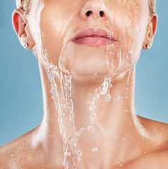 Image showing Woman face, water splash and cleaning skin, wellness and shower in blue studio mockup background. Mock up, model cosmetic and cleaning body with facial wash, clean and bath for hygiene and hydration
