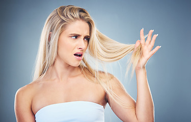 Image showing Hair care problem, angry and woman frustrated with damaged hair, split ends or bad haircut. Trichology crisis, hair disaster and model unhappy with hair loss from shampoo routine on studio background