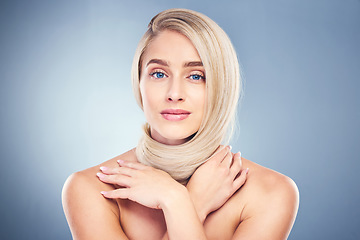 Image showing Beauty, hair and blonde with portrait of woman for shampoo, salon and health. Wellness, skincare and makeup with girl model for cosmetics, keratin and shine against a blue background in studio