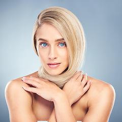 Image showing Beauty, blonde hair and portrait of woman in studio on blue background for haircare, products and hairsalon. Fashion, style and young female with healthy, smooth texture and perfect around neck.