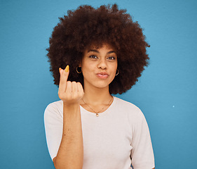 Image showing Hand, korean symbol and portrait of happy woman with an afro from Puerto Rico in the studio. Happiness, care and girl model doing kpop i love you gesture from Korea while isolated by blue background.