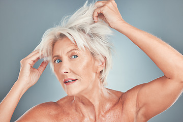 Image showing Senior woman, messy hair and stress for salon care, cosmetics or cut against a grey studio background. Portrait of elderly female having a bad hair day looking for makeover or cosmetic treatment
