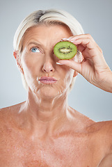 Image showing Elderly woman, beauty cosmetic and eye care anti aging wellness treatment with fruit in studio. Mature model lips, natural fruit vitamins and facial collagen healthcare against grey background
