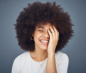 Image showing Comic, happy and black woman with a smile for memory, comedy and fashion against a grey studio background. Hair care, salon and young African girl with an afro while crazy, funny and healthy