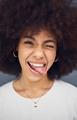 Image showing Funny, black woman and with tongue out happy, smile and content with happiness, silly and joke. African American female, young girl and with afro for happiness, crazy and positive with humor and fun.