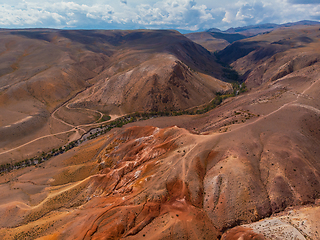 Image showing Aerial shot of the textured yellow nad red mountains resembling the surface of Mars