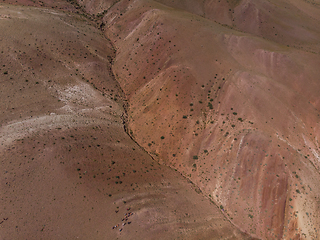 Image showing Aerial shot of the textured yellow nad red mountains resembling the surface of Mars