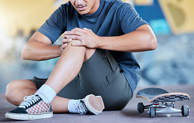 Image showing Man, skateboard and knee injury in street, city or outdoors after stunt training accident or failure. Sports, skateboarding and skater with muscle inflammation, leg or knee pain at urban skate park.