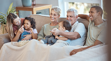 Image showing Family, children and watching tv grandparents, parents and kids together on a sofa in the living room of their home. Movie, television and film with a man, woman and grandkids bonding over a video