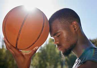 Image showing Basketball, ball and hope of black man thinking and praying outdoor at a community park or sports court for exercise, training and fitness. Face of athlete playing street ball for health and wellness