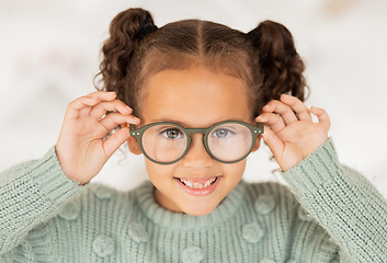 Image showing Glasses, frame and portrait of child with vision, eye care and eyes healthcare, wellness and insurance trust, choice and shopping. Happy kid with lens check, test or assessment at an optometry store